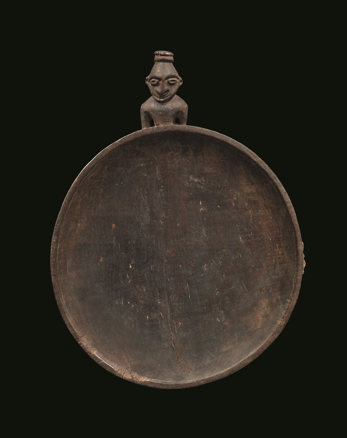 A very fine and early food dish carved with a stylized ancestor figure projecting from one edge | MasterArt